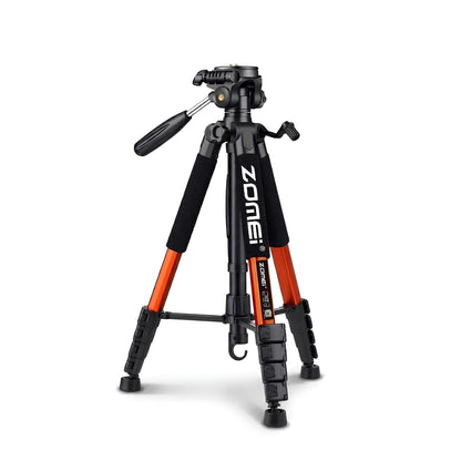Trépied Zomei orange et noir en position basse, tête panoramique 3 voies noire avec double levier, grips mousse noirs sur les jambes oranges, vue trois quarts sur fond blanc