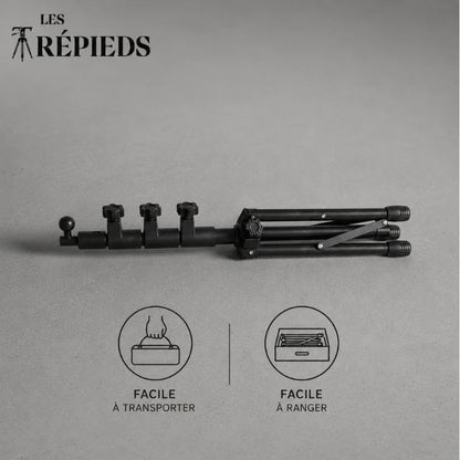Trépied tablette noir replié à l'horizontale posé sur fond gris, logo Les Trépieds, avec les mentions facile à transporter et facile à ranger
