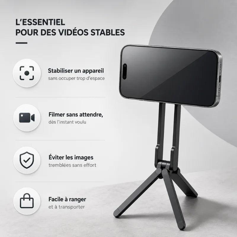 Mini trépied noir magnétique avec iPhone fixé par aimant posé sur fond gris clair