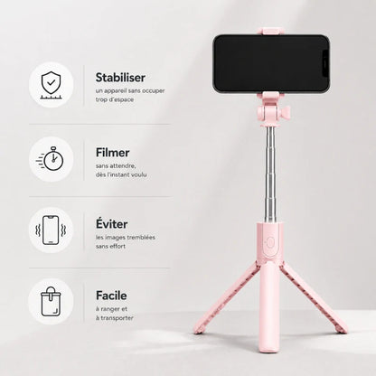 Mini trépied rose déplié avec un smartphone noir dans le support sur fond gris clair, avec liste des utilisations : stabiliser, filmer, éviter les tremblements, facile à ranger