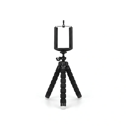 Mini trépied flexible noir avec jambes articulees en mousse et support téléphone noir en haut, rotule à bille noire, sur fond blanc
