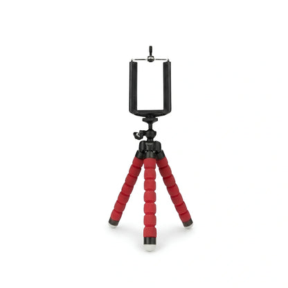 Mini trépied flexible rouge avec jambes articulees en mousse rouge et support téléphone noir en haut, rotule à bille noire, sur fond blanc