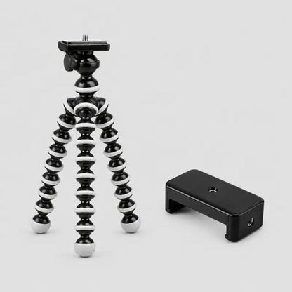 Trépied flexible noir et blanc a côté d un support téléphone noir compact - tête rotative avec plaque de fixation et molette, sur fond gris