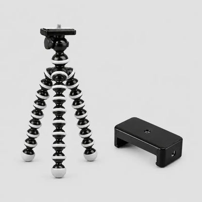 Trépied flexible noir et blanc a côté d un support téléphone noir compact - tête rotative avec plaque de fixation et molette, sur fond gris