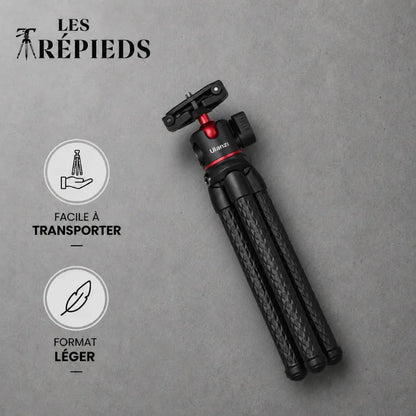 Trépied flexible noir plié à plat avec logo Les Trépieds sur fond gris béton, facile à transporter et léger