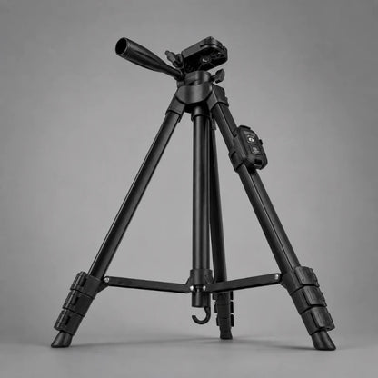 Trépied iPhone noir en position basse sur fond gris, tête 3 voies noire avec levier, télécommande Bluetooth noire sur la tige, jambes très écartées